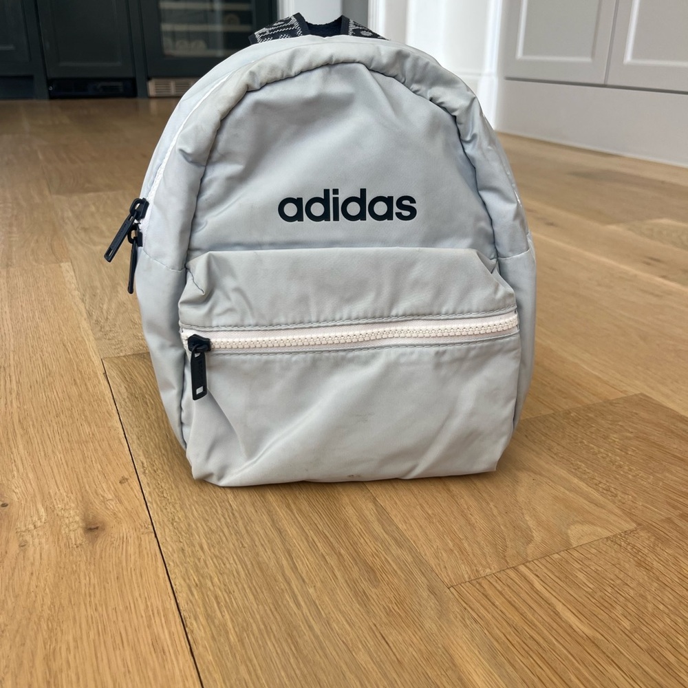 Light blue and navy champion backpack with little stain on the bottom